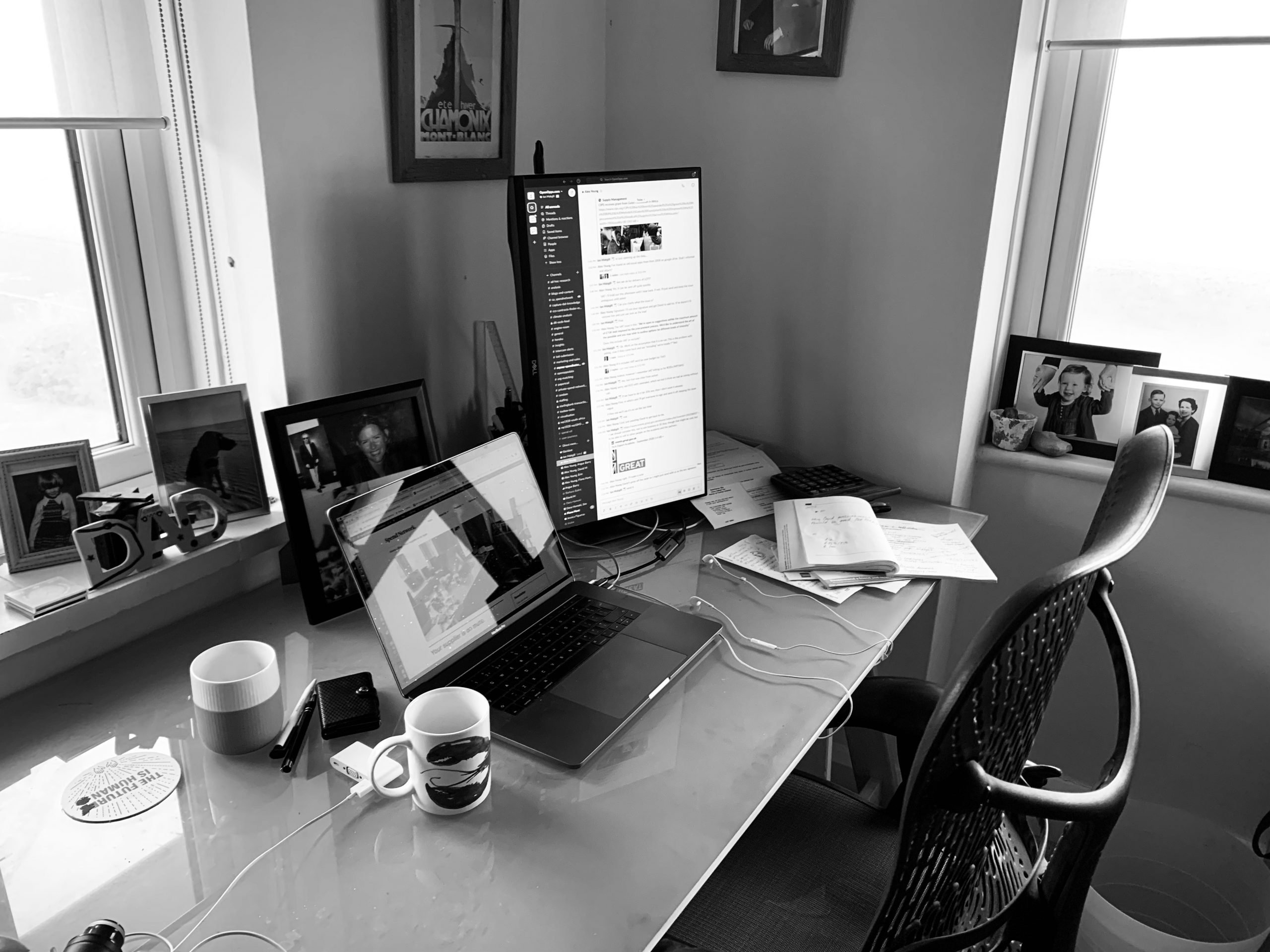 Desk with screens, chair and cups